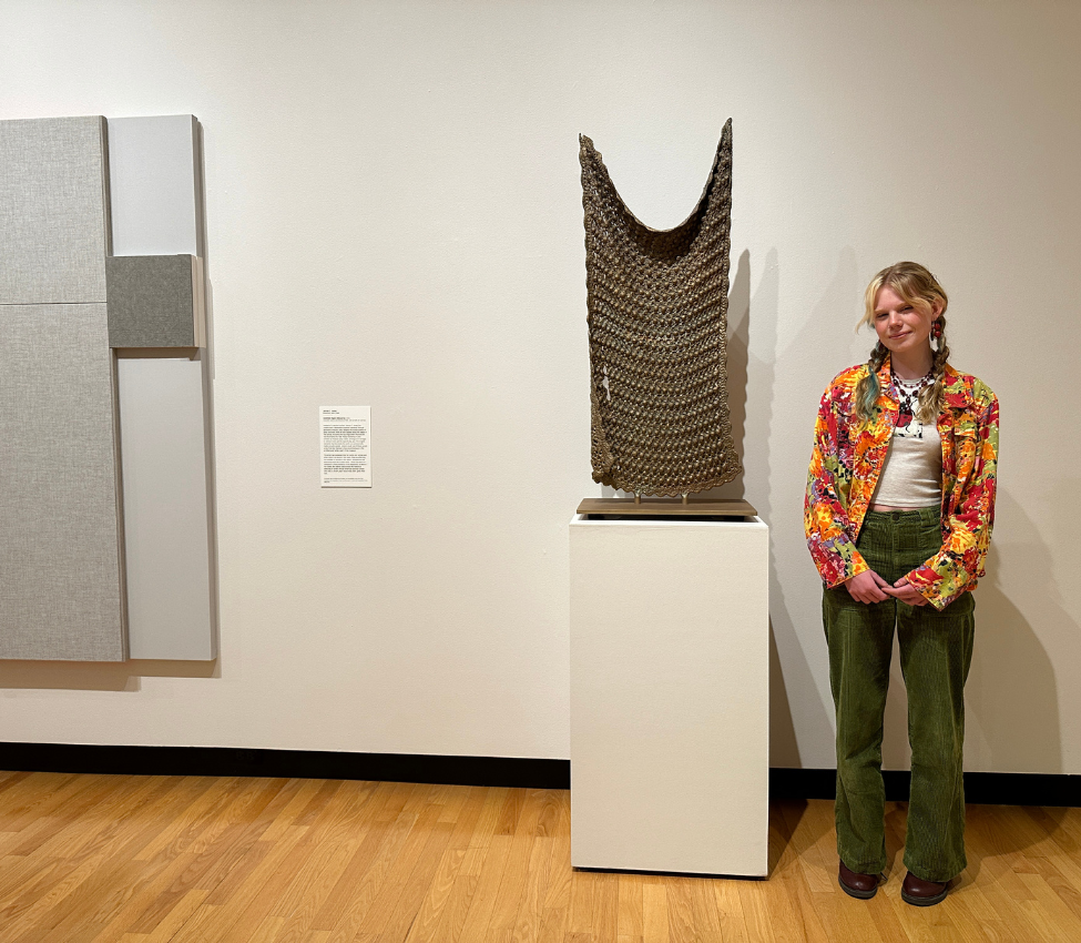 Photo of Madigan Breiding ’26 in front of Untitled by Michelle Grabner