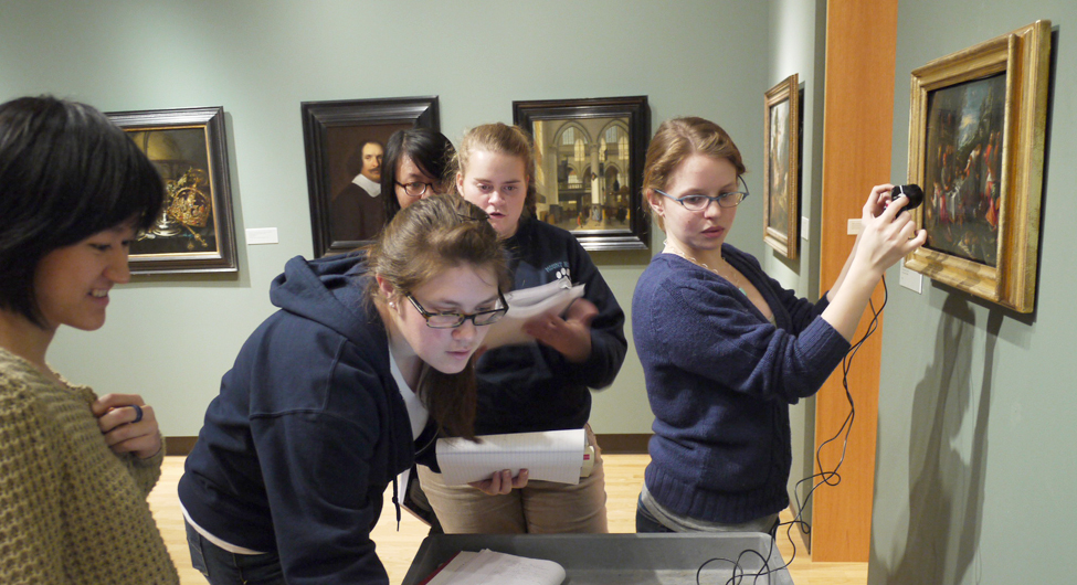 Chemistry students using infrared technology to look beneath a painting's surface