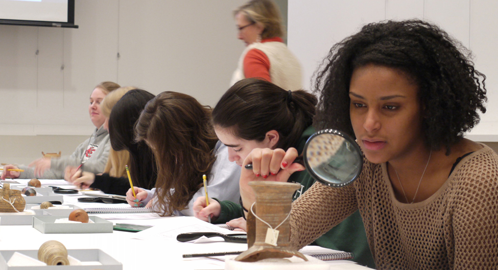 Students look closely at ancient ceramics in the Carson Teaching Gallery