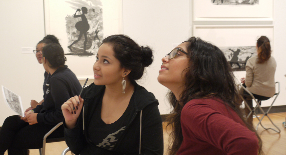 Students in the special exhibition gallery discuss Kara Walker prints