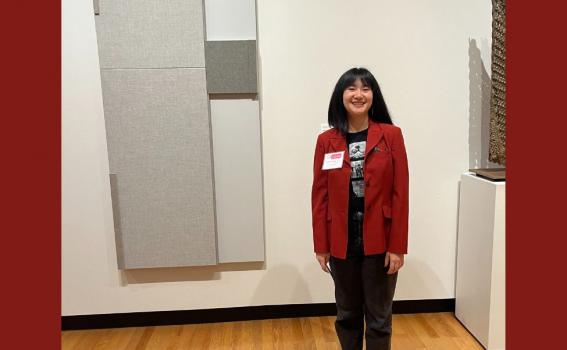 Photo of Emma Harrison ’26 in front of Untitled (Open Measure) by Jennie C. Jones