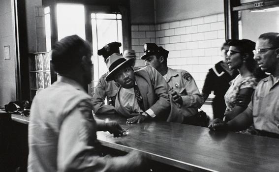 Charles Moore (American, 1931-2010), 	Dr. Martin Luther King, Jr. is arrested for loitering outside a courtroom where his friend and associate Ralph Abernathy is appearing for a trial, from Pictures That Made a Difference: The Civil Rights Movement, 1958 