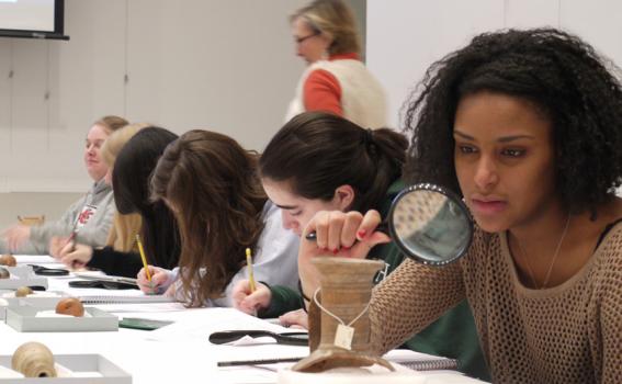 Students look closely at ancient ceramics in the Carson Teaching Gallery