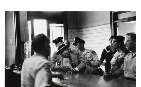 Charles Moore (American, 1931-2010), 	Dr. Martin Luther King, Jr. is arrested for loitering outside a courtroom where his friend and associate Ralph Abernathy is appearing for a trial, from Pictures That Made a Difference: The Civil Rights Movement, 1958 