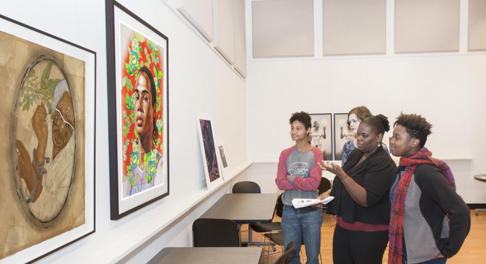 Students in Professor Kimberly Brown's course, Black Women Writers, discuss portraits by contemporary artists Frohawk Two Feathers and Kehinde Wiley Students in Professor Kimberly Brown's course, Black Women Writers, discuss portraits by contemporary artists Frohawk Two Feathers and Kehinde Wiley