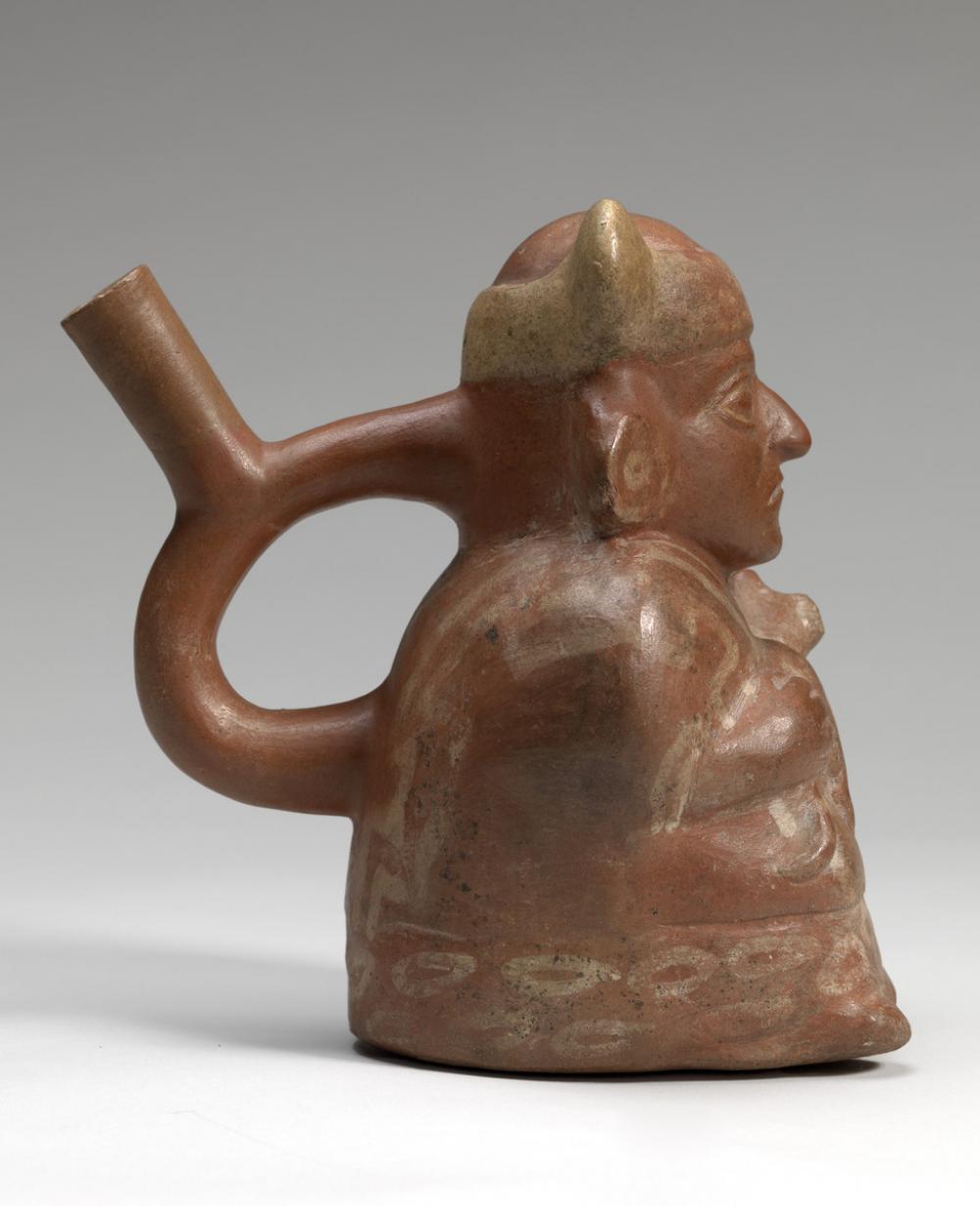 Moche, Stirrup-spouted vessel in form of a figure holding a feline Moche, Stirrup-spouted vessel in form of a figure holding a feline