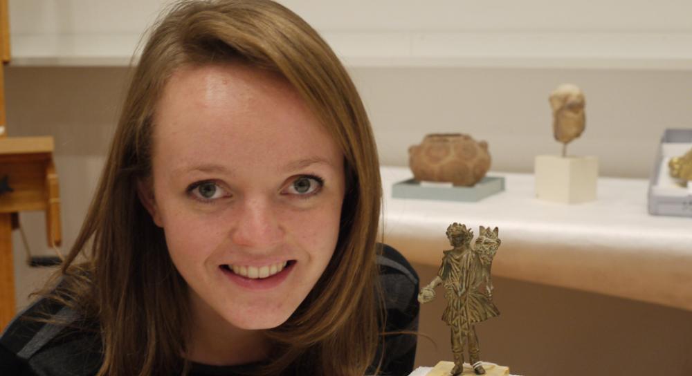 Student intern and her research object, an ancient Roman Lar Student intern and her research object, an ancient Roman Lar