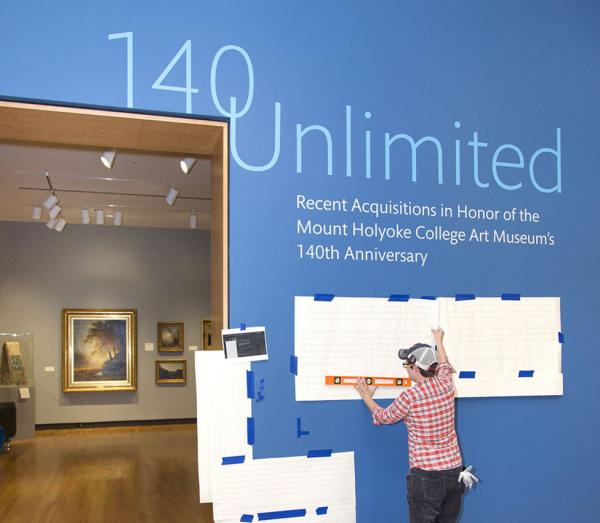 Museum Preparator Jacqueline Finnegan installs vinyl Museum Preparator Jacqueline Finnegan installs vinyl