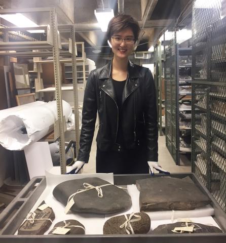 LYNK intern Priscilla (Qizhen) Zhang '19 examines Tibetan Mani Stones in Museum storage in summer 2018.