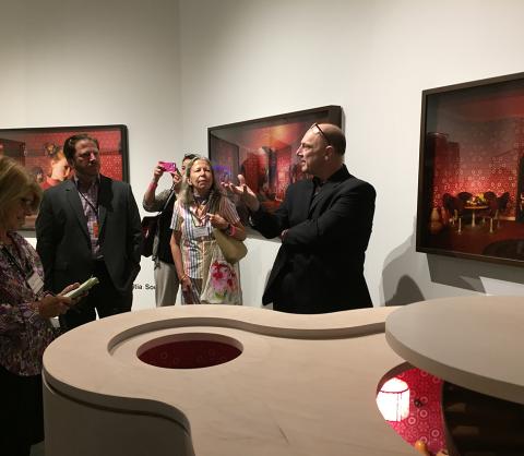 Members of MHCAM's Friends of Art view photographs by French artist Laetitia Soulier at the Claire Oliver booth at Art Basel Miami Beach.