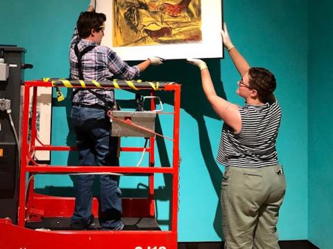 Jackie Finnegan (L) and Bran Kroc '20 (R) installing a print