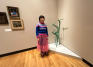 Photo of Olive Xia ’26 in front of Strange Bird by Isamu Noguchi