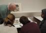 Assistant Curator Aaron Miller shows students a silver vessel