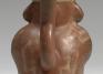 Moche, Stirrup-spouted vessel in form of a figure holding a feline