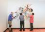 Bob Riddle, Jacqueline Finnegan, and Linda Best install a Judy Pfaff sculpture