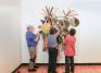 Bob Riddle, Jacqueline Finnegan, and Linda Best install a Judy Pfaff sculpture