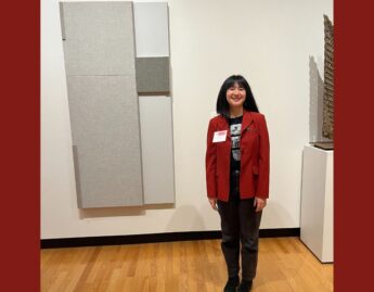 Photo of Emma Harrison ’26 in front of Untitled (Open Measure) by Jennie C. Jones