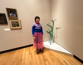 Photo of Olive Xia ’26 in front of Strange Bird by Isamu Noguchi