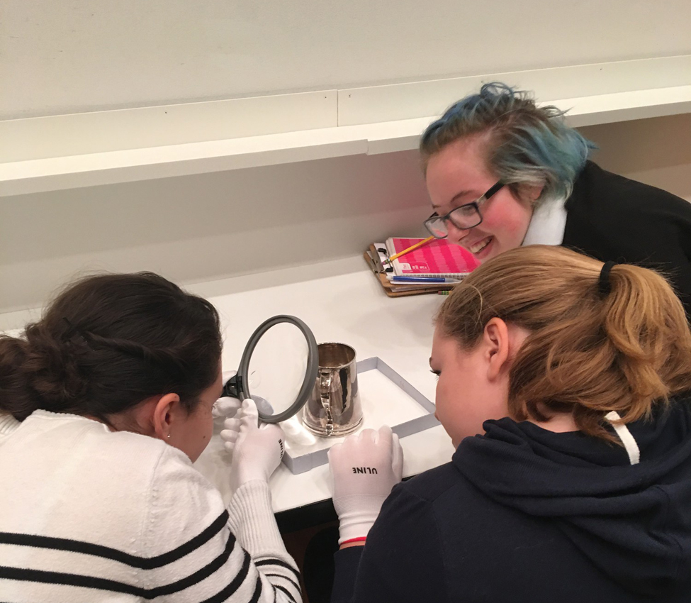 Place and Power in the American West and Pacific World, Examples of material culture provide students with a window into early American and indigenous histories, Assistant Curator Aaron Miller shows students a silver vessel, History students use a magnifying glass to get a closer look