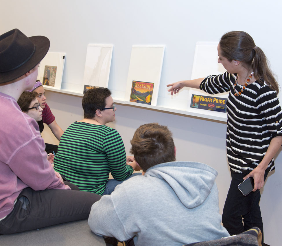 Place and Power in the American West and Pacific World, Examples of material culture provide students with a window into early American and indigenous histories, Assistant Curator Aaron Miller shows students a silver vessel, History students use a magnifying glass to get a closer look