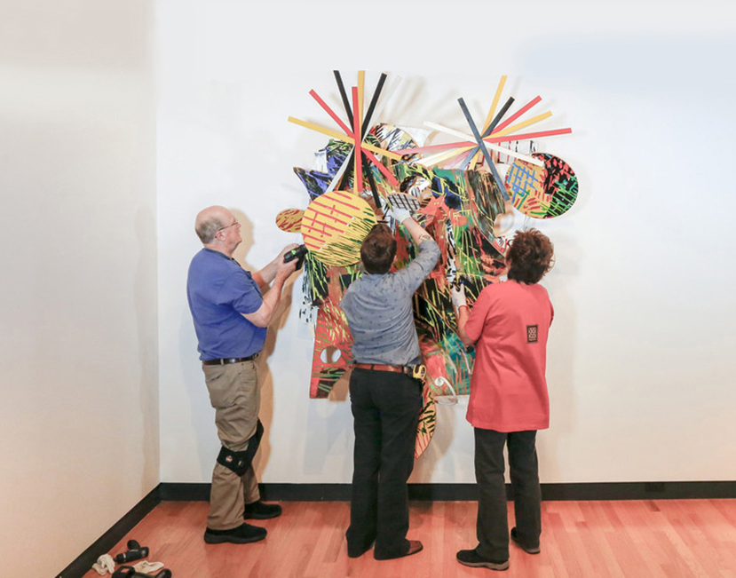 Bob Riddle, Jacqueline Finnegan, and Linda Best install a Judy Pfaff sculpture, Bob Riddle, Jacqueline Finnegan, and Linda Best install a Judy Pfaff sculpture, Jacqueline Finnegan installs a Judy Pfaff sculpture, Jacqueline Finnegan installs a Judy Pfaff sculpture, Bob Riddle, Jacqueline Finnegan, and Linda Best take a bow after completing the installation of a Judy Pfaff sculpture