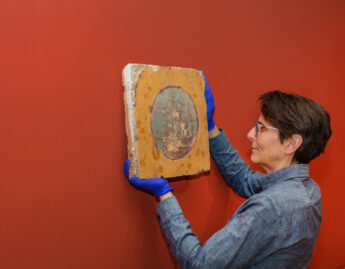 Preparator Ethel Poindexter with a fresco, March 2024