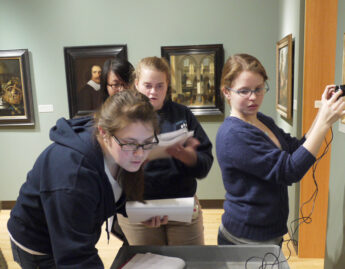 Chemistry students using infrared technology to look beneath a painting's surface