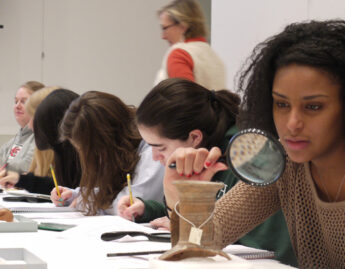 Students look closely at ancient ceramics in the Carson Teaching Gallery
