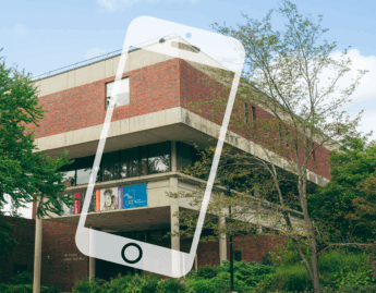A phone superimposed on the MHCAMM building
